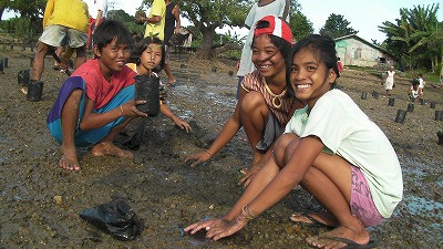 Students participate in tree planting as a class.